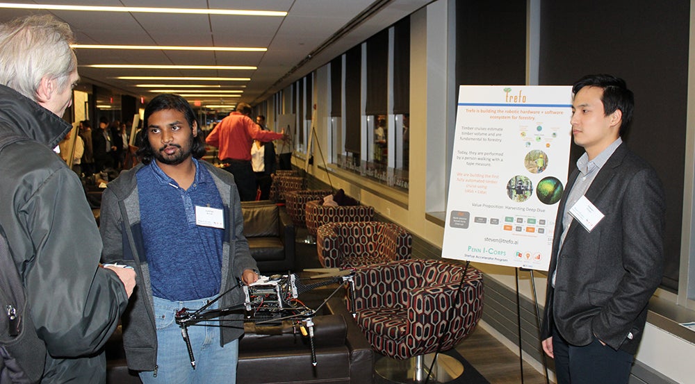 Trefo, an I-Corp program graduate, talking with a Celebration of Innovation attendee