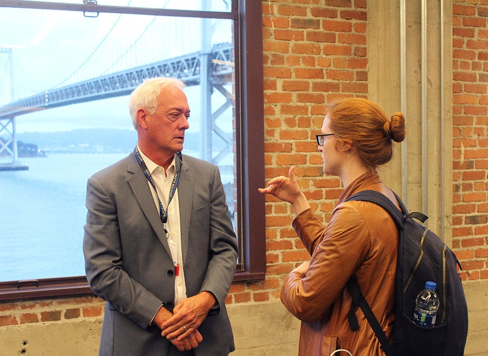 Glen N. Gaulton, PhD (Left) talking to event attendee